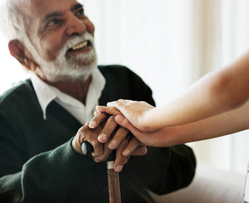Grandson holding grandpa's hands